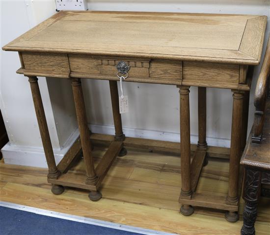 An oak desk in the manner of Philip Webb W.96cm